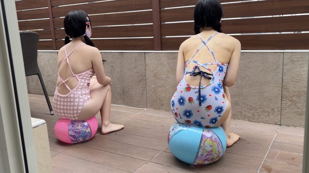 水着姿の女の子のお尻に潰されるビーチボール